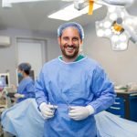 portrait-male-surgeon-operation-theater-looking-camera-doctor-scrubs-medical-mask-modern-hospital-operating-theater_657921-1051